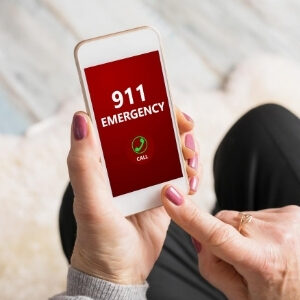 Woman calling 911 on cell phone